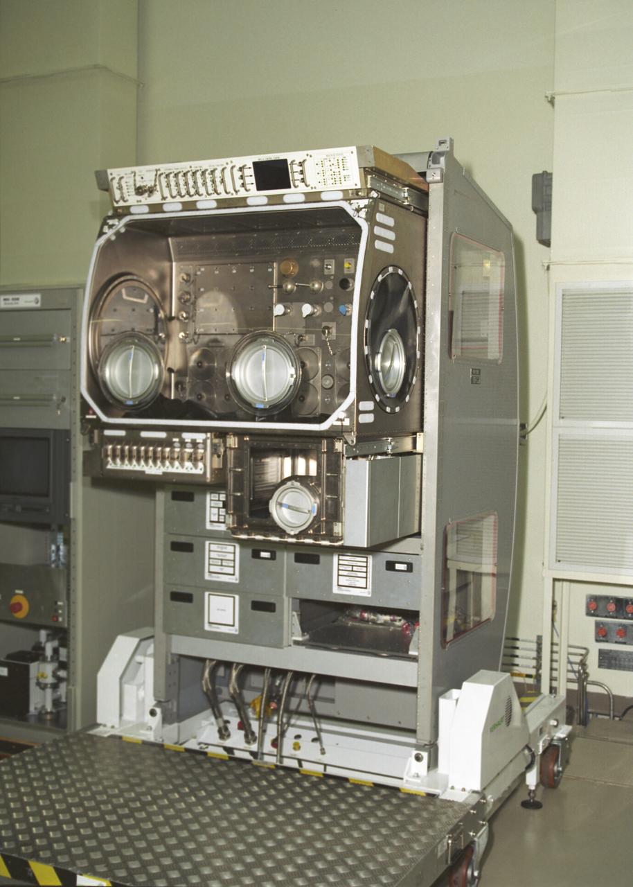 The Microgravity Science Glovebox Ground Unit, delivered to the Marshall Space Flight Center on August 30, 2002, will be used at Marshall's Microgravity Development Laboratory to test experiment hardware before it is installed in the flight glovebox aboard the International Space Station (ISS) U.S. Laboratory Module, Destiny. The glovebox is a sealed container with built in gloves on its sides and fronts that enables astronauts to work safely with experiments that involve fluids, flames, particles, and fumes that need to be safely contained.