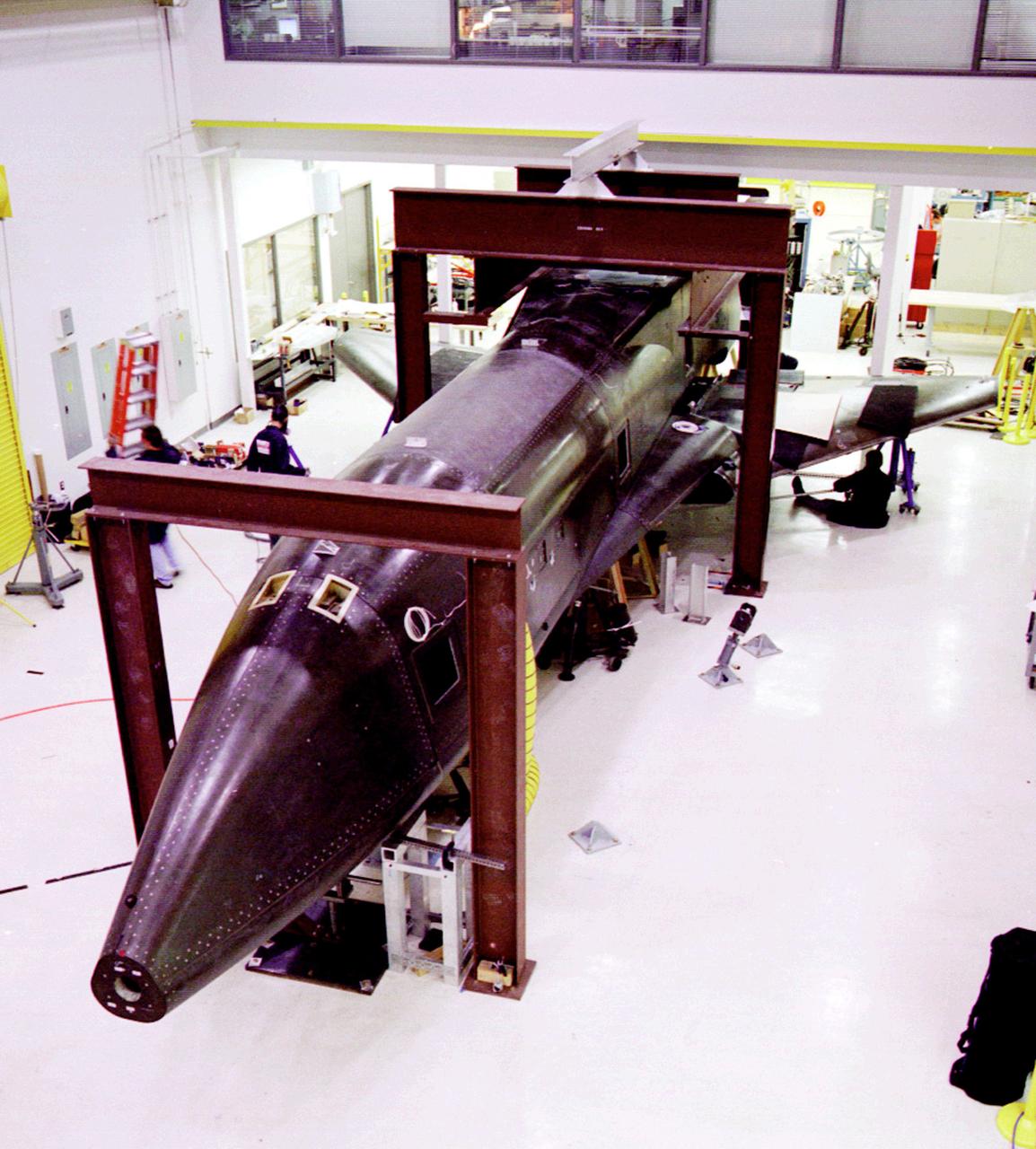 Pictured in the high bay, is the X-34 Technology Demonstrator in the process of completion. The X-34 wass part of NASA's Pathfinder Program which demonstrated advanced space transportation technologies through the use of flight experiments and experimental vehicles. These technology demonstrators and flight experiments supported the Agency's goal of dramatically reducing the cost of access to space and defined the future of space transportation pushing technology into a new era of space development and exploration at the dawn of the new century. The X-34 program was cancelled in 2001.