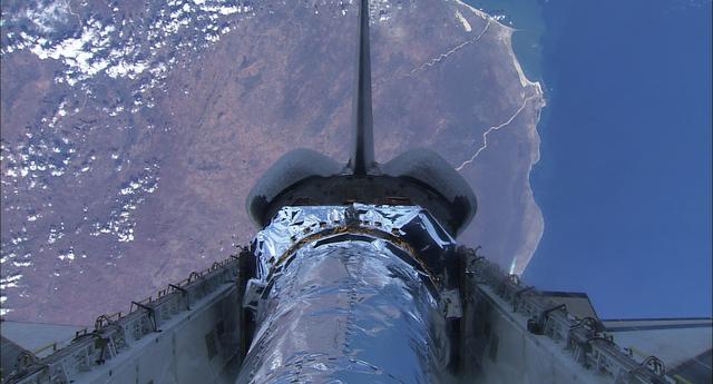 99-E-10024 (23 July 1999) --- This pre-deployment view of the Chandra X-Ray observatory backdropped against part of Namibia was recorded with the HDTV Camcorder from inside Columbia's crew cabin.