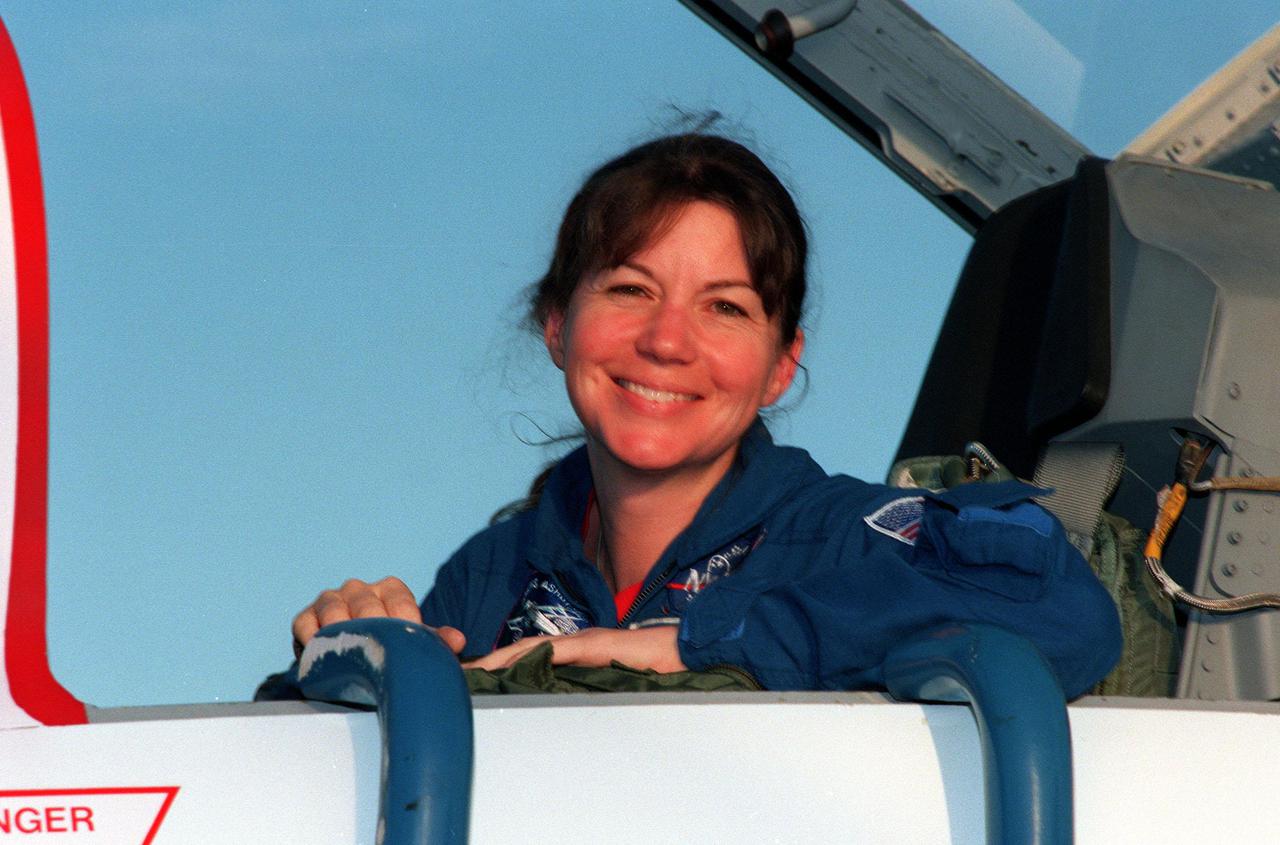 STS-93 Mission Specialist Catherine G. 'Cady' Coleman (Ph.D.) smiles upon her arrival at KSC's Shuttle Landing Facility aboard a T-38 jet aircraft. She and other crew members Commander Eileen Collins, Pilot Jeffrey S. Ashby, and Mission Specialists Steven A. Hawley (Ph.D.) and Michel Tognini of France, with the Centre National d'Etudes Spatiales (CNES), are arriving for pre-launch activities. Coleman is making her second Shuttle flight. The primary mission of STS-93 is the release of the Chandra X-ray Observatory, which will allow scientists from around the world to study some of the most distant, powerful and dynamic objects in the universe. The new telescope is 20 to 50 times more sensitive than any previous X-ray telescope and is expected to unlock the secrets of supernovae, quasars and black holes