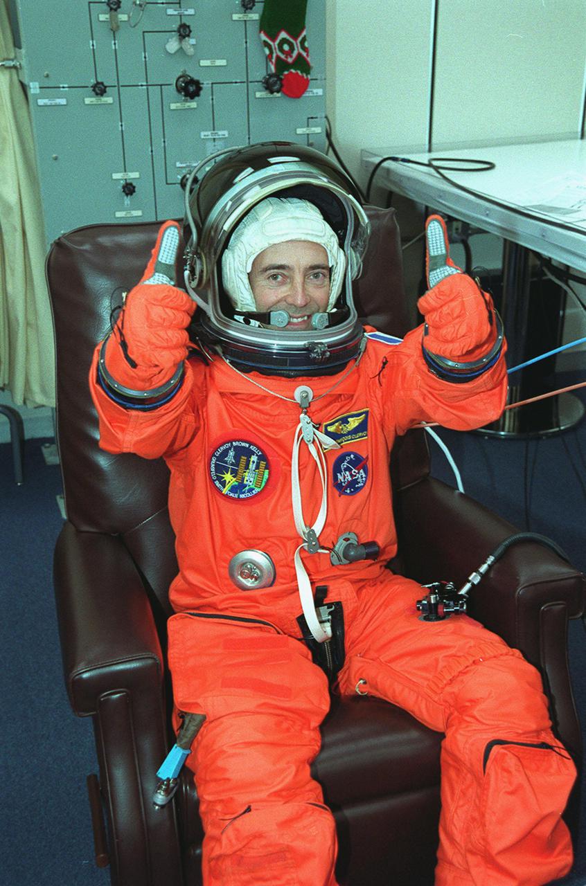 After donning his launch and entry suit, STS-103 Mission Specialist Jean-Francois Clervoy of France gives two thumbs up to show he is ready for the second launch attempt of Space Shuttle Discovery. The previous launch attempt on Dec. 17 was scrubbed about 8:52 p.m. due to numerous violations of weather launch commit criteria at KSC. Clervoy and fellow crew members Commander Curtis L. Brown Jr., Pilot Scott J. Kelly and Mission Specialists Steven L. Smith, C. Michael Foale (Ph.D.), John M. Grunsfeld (Ph.D.) and Claude Nicollier of Switzerland are scheduled to lift off at 7:50 p.m. EST Dec. 19 on mission STS-103, servicing the Hubble Space Telescope. Objectives for the nearly eight-day mission include replacing gyroscopes and an old computer, installing another solid state recorder, and replacing damaged insulation in the telescope. Discovery is expected to land at KSC Monday, Dec. 27, at about 5:24 p.m. EST