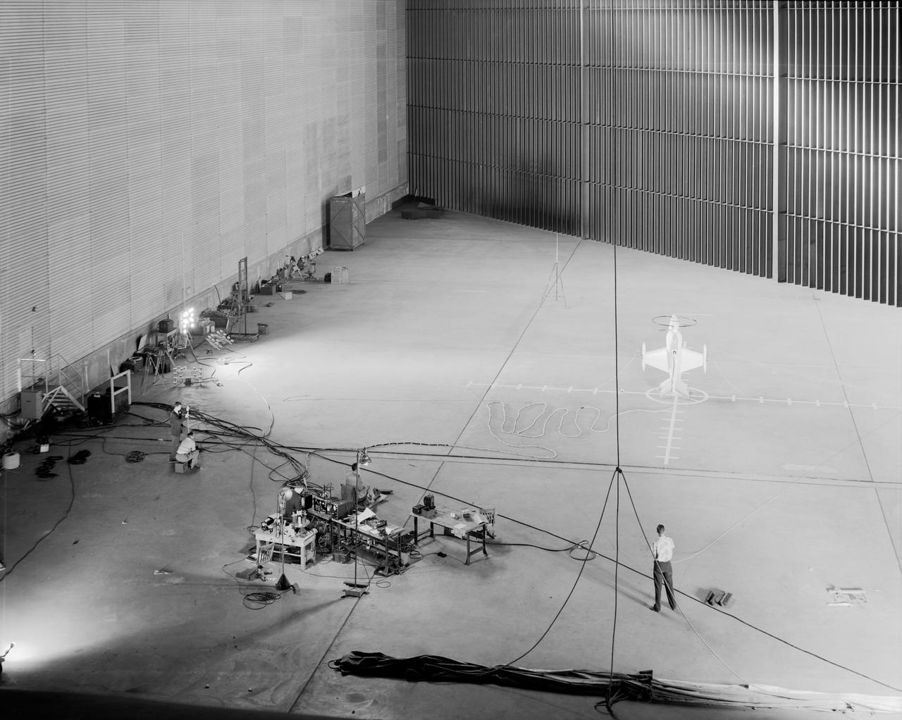 Wide shot of 40x 80 wind tunnel settling chamber with Lockheed XFV-1 model.  Project engineer Mark Kelly (not shown). Remote controlled model flown in the settling chamber of the 40x80 wind tunnel. Electric motors in the model, controlled the counter-rotating propellers to test vertical takeoff. Test no. 71