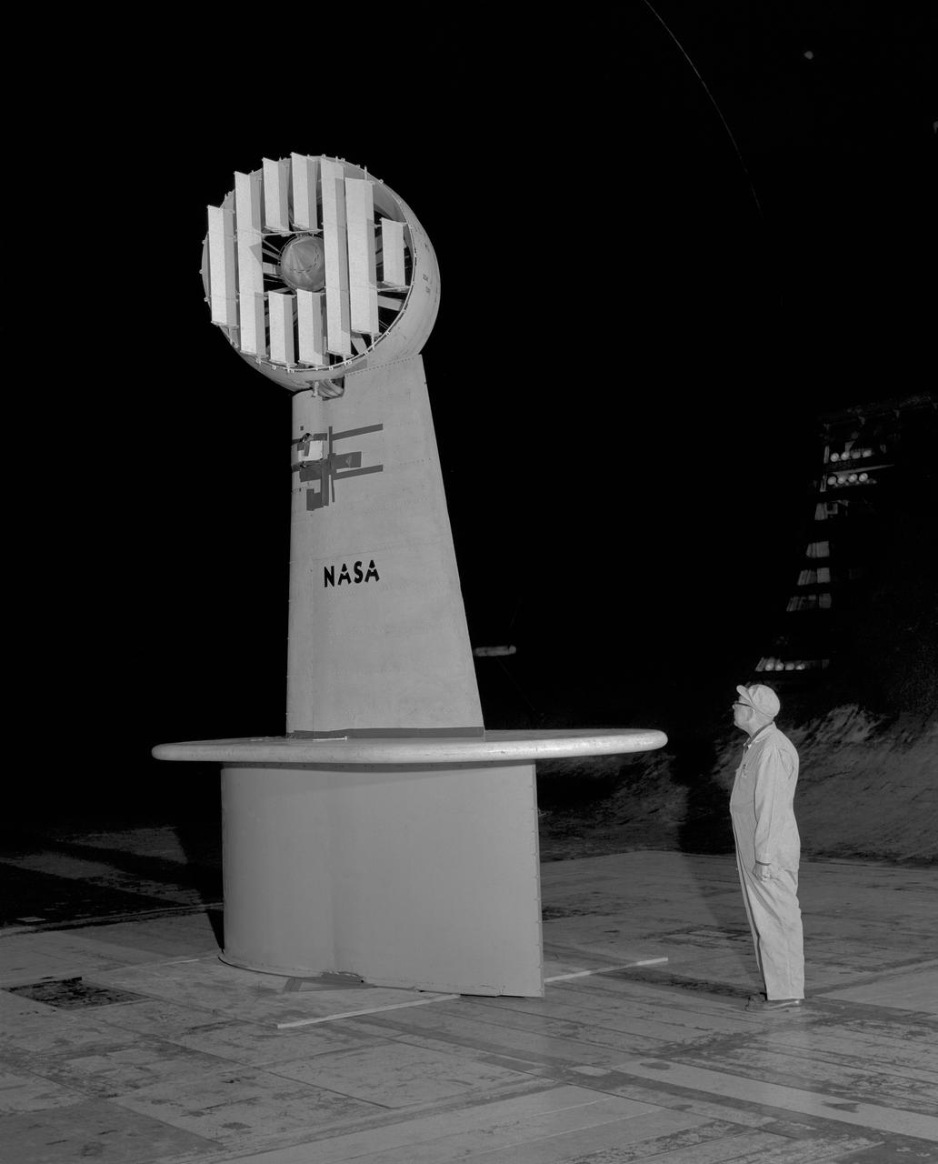 3/4 rear view of ducted fan model with cascade exit vane in Ames 40x80 foot wind tunnel, with Tom Seymore, mechanic for Ames.