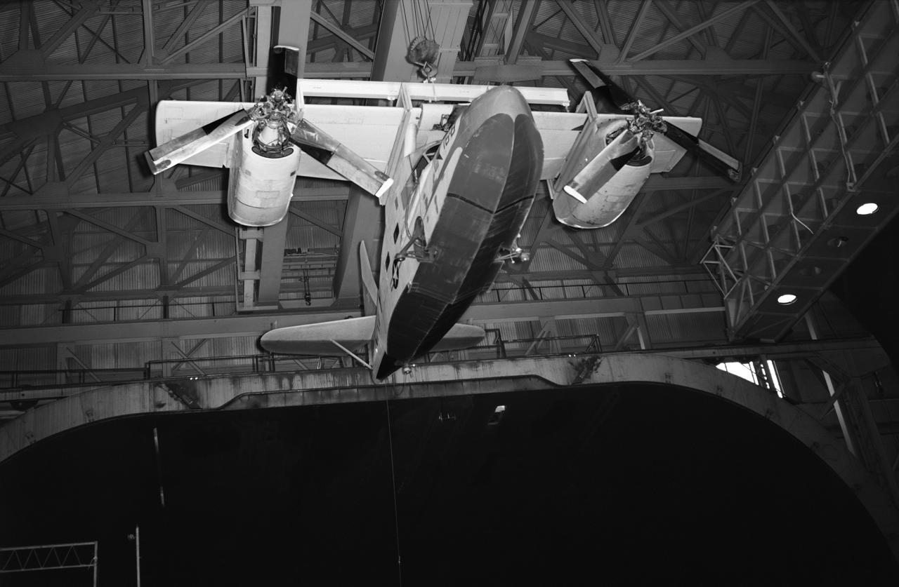 Test No. 175  Kaman K-16 being lowered into the 40x80 foot wind tunnel at NASA's Ames Research Center, viewed from the front. Kaman K-16B was an experimental tilt wing aircraft, it used the fuselage of a JRF-5 and was powered by two General Electric YT58-GE-2A engines.