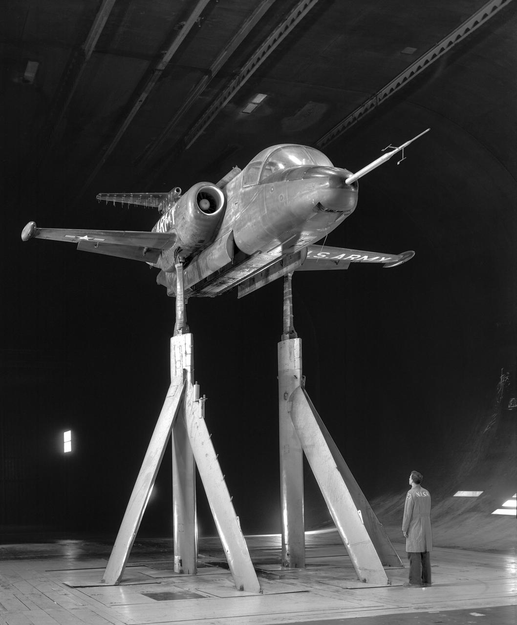 3/4 front view of XV-4A Hummingbird VTOL Research Vehicle in Ames 40x80 wind tunnel with Tom Wills in Photo.