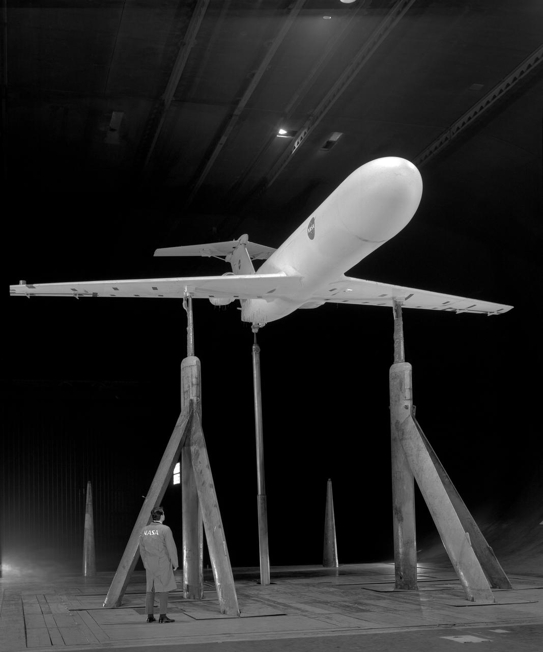 Deep Stall Model in Ames 40x80 foot Wind Tunnel. 3/4 front view from below of swept wing jet transport with T-Tail and Aft Engins, with Art Morris.
