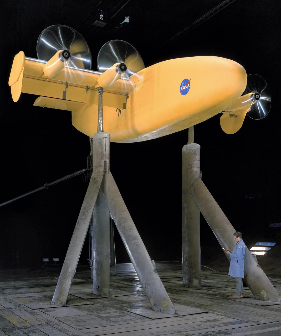 4 propeller model with rotating cylinder flap.  Propellers running.  3/4 front view. DAVE JONES (PROPS TURNING)