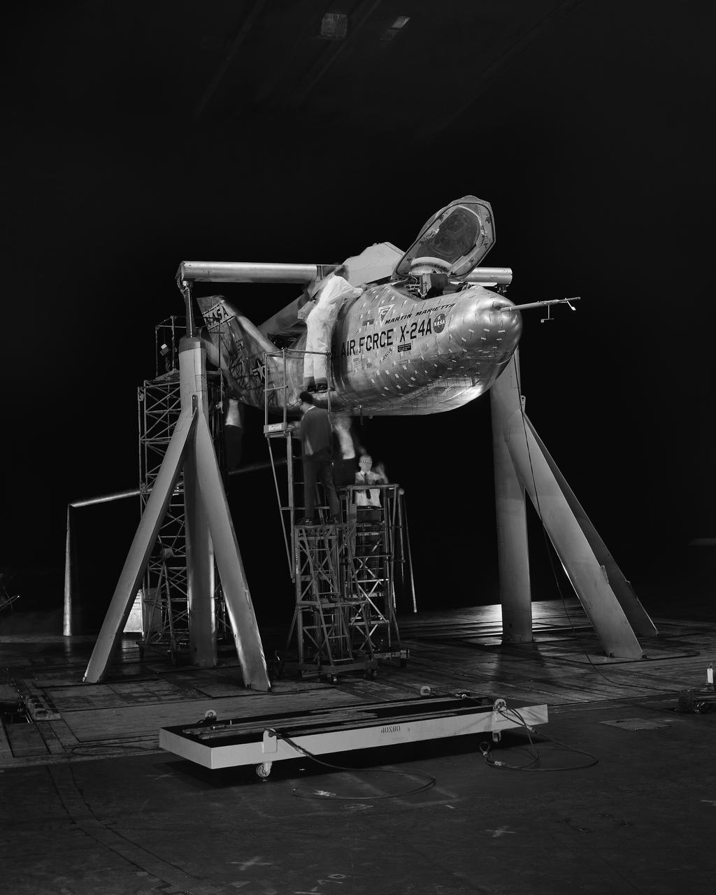 3/4 front view of Martin X-24A lifting body, mounted on B-52 mount.