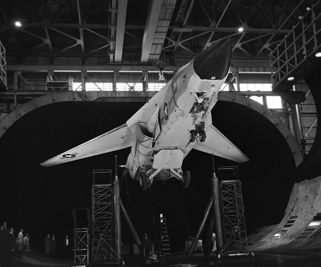 Installation Photos, 3/4 front view from below. F-111B in Ames 40x80 Foot Wind Tunnel.  The General Dynamics/Grumman F-111B was a long-range carrier-based interceptor aircraft that was planned to be a follow-on to the F-4 Phantom II. The F-111B was developed in the 1960s by General Dynamics in conjunction with Grumman for the United States Navy (USN) as part of the joint Tactical Fighter Experimental (TFX) with the United States Air Force (USAF) to produce a common fighter for the services that could perform a variety of missions. It incorporated innovations such as variable-geometry wings, afterburning turbofan engines, and a long-range radar and missile weapons system.