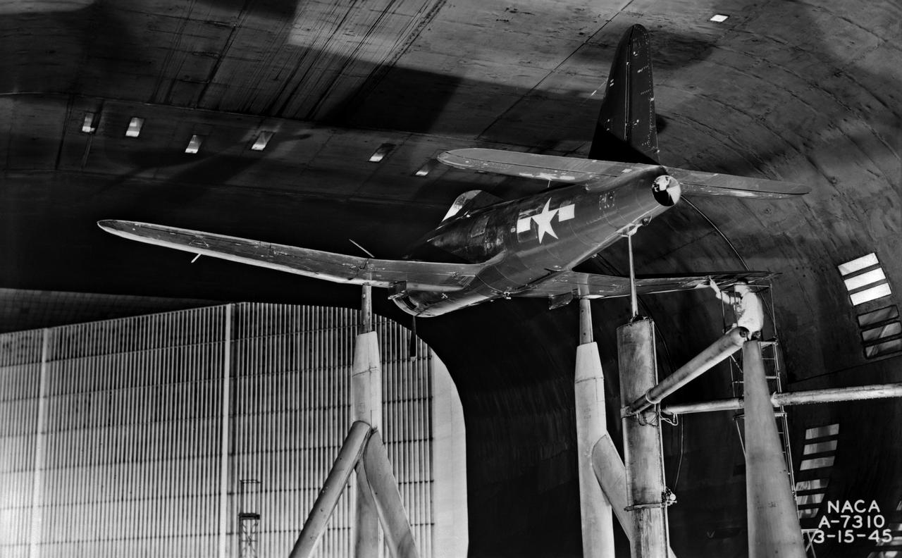 3/4 rear view of the Ryan FR-1 airplane mounted in the NACA Ames 40x80 foot wind tunnel from below. Production configuration.