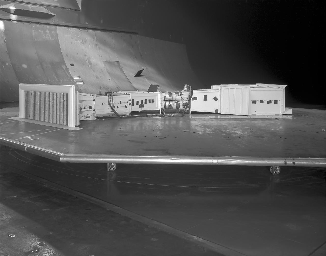 (03/12/1976) 1/50 scale model of the 80x120 foot wind tunnel model (NFAC) in the test section of the 40x80 foot wind tunnel. Model mounted on a rotating ground board designed for this test, viewed from the west, oriented for North wind.