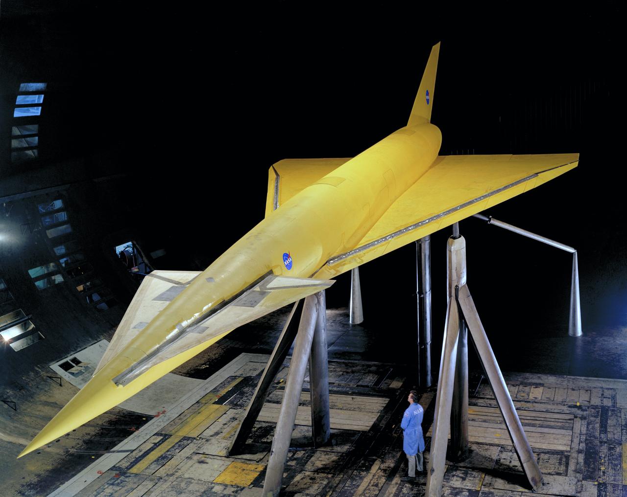 High 3/4 top front view of model in Ames 40x80 foot wind tunnel. Bob Bishop in lower right. Delta Wing with Conard.