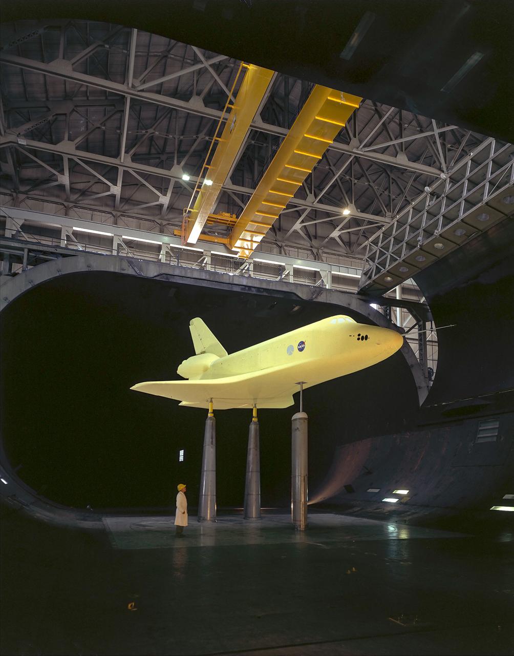 1/3 scale model of space shuttle, 3/4 lower front view, test section overhead doors open.