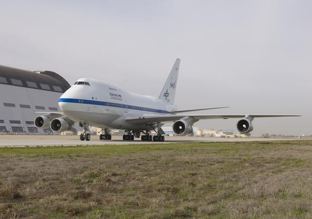 NASA image: NASA's SOFIA airborne observatory taxis past Hangar 1, the 1930s-era dirigible hangar at Moffett Field, during its first visit to NASA Ames Research Center