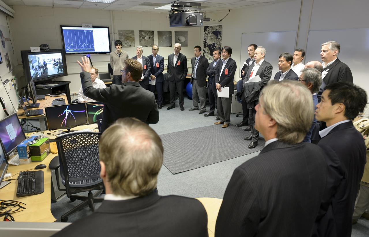 Senior executives from the Renault-Nissan Alliance, including Carlos Ghosn, chairman and CEO of Nissan, and Jose Munoz, chairman of Nissan North America, visited Ames for meetings and a showcase of the technical partnership between NASA and Nissan North America. After briefings, the group gathers in at the Autonomous Sciences Research Facility for a remote vehicle monitoring demo.