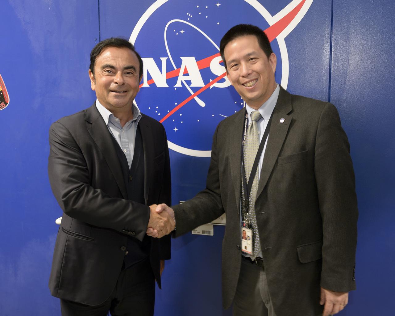 Senior executives from the Renault-Nissan Alliance, including Carlos Ghosn, chairman and CEO of Nissan, and Jose Munoz, chairman of Nissan North America, visited Ames for meetings and a showcase of the technical partnership between NASA and Nissan North America.  Shown here on left is Carlos Ghosn, CEO, Nissan on right Eugene Tu, Ames Center Director in front to the NASA sign at the VMS Facility at Ames Research Center ,CA.
