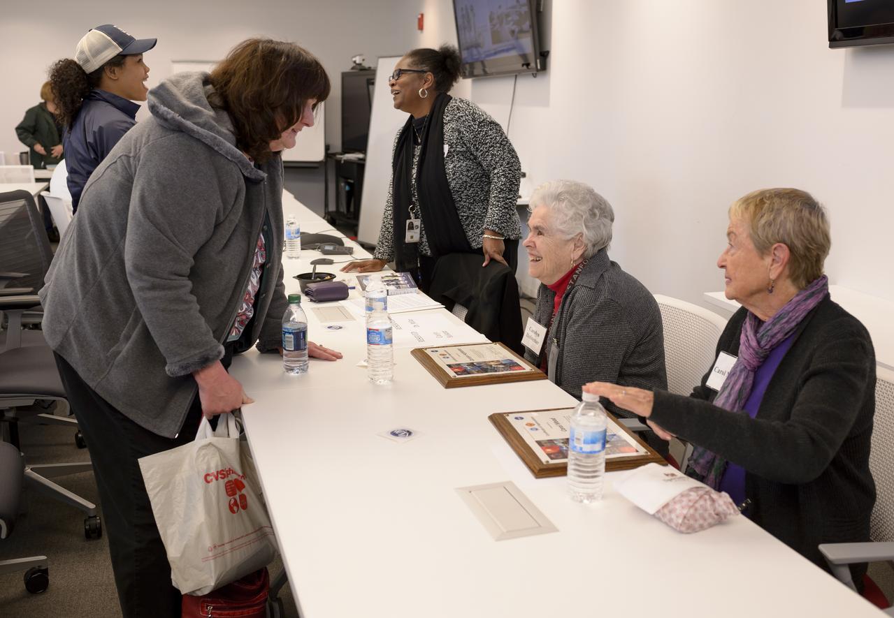 Ames Women's Influence Network (WIN) Hidden Figures talk with "Computers" Carolyn Hofstetter and Carol Mead co-sponsored by the AAAG. Left to right Barbara Miller, Ames EEO, Computers Carolyn Hoffstetter and Carol Mead, talking to Carolyn Hofstetter is Arlene Spencer