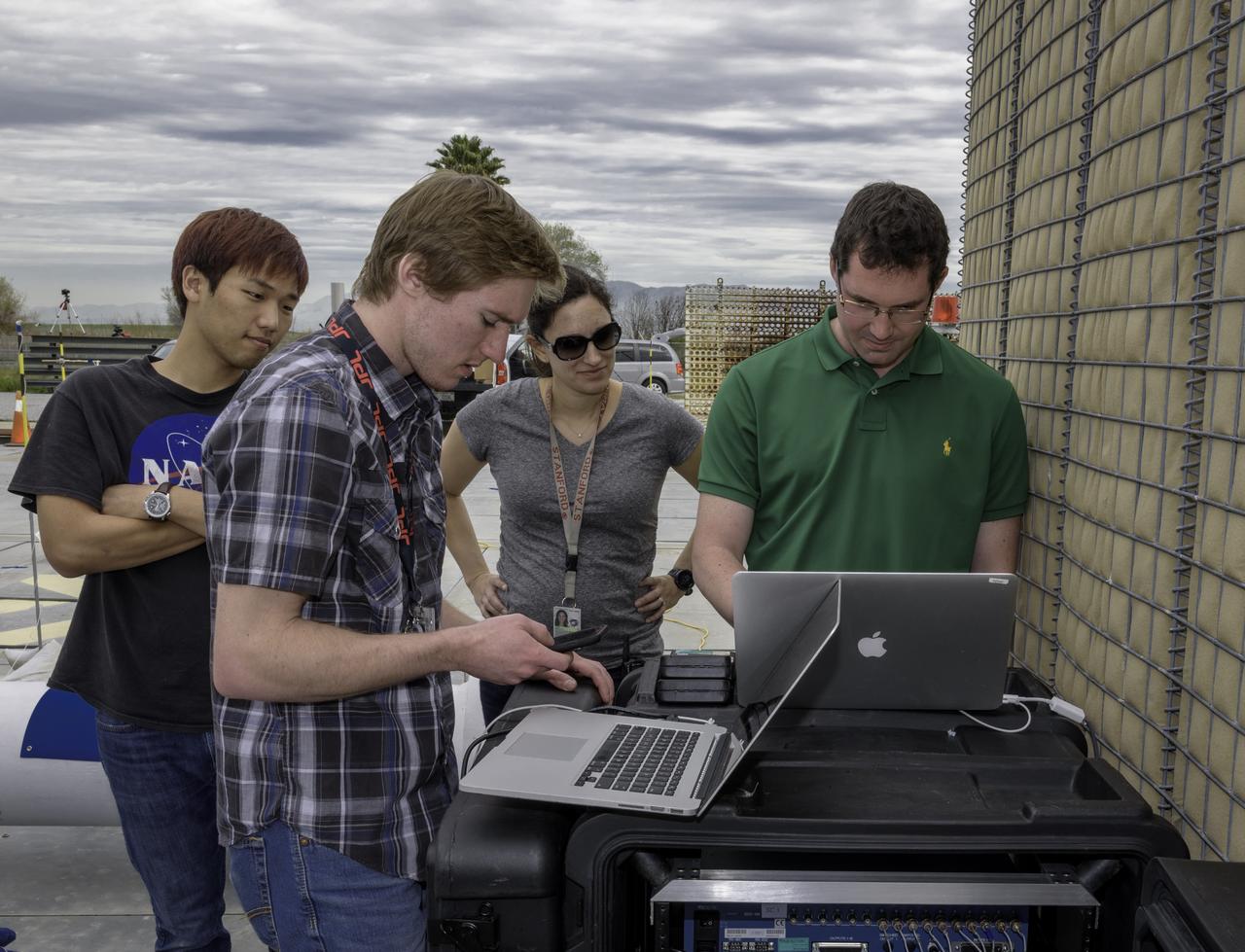 From Left to Right:  1.       Hunjoo Kim (NASA JPL) 2.       Kyle Botteon (NASA JPL) 3.       Ashley Karp (NASA JPL) 4.       Brian Schratz (NASA JPL) Testing the Peregrine Hybrid Rocket Engine at the Outdoor Aerodynamic Research Facility (building N249, OARF) at Ames Research Center.