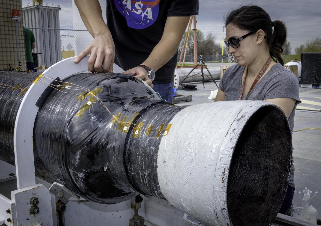 Hunjoo Kim, NASA JPL (Left) and Ashley Karp, NASA JPL (Right) attaching heat sensors the Peregrine Hybrid Rocket Engine prior to its test at the Outdoor Aerodynamic Research Facility (OARF, N-249) at NASA’s Ames Research Center.