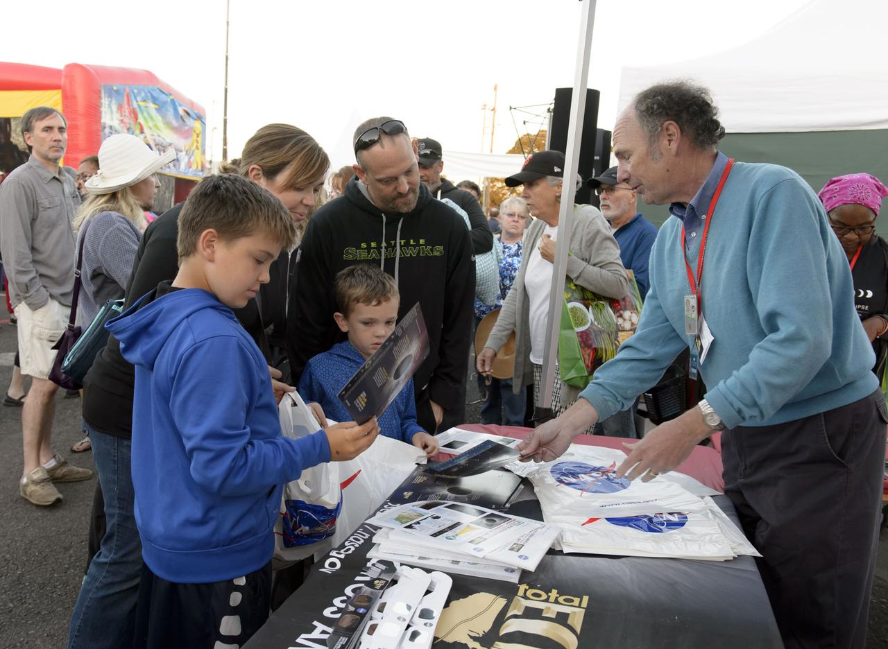 Visitors at the a NASA booth during the 2017 Solar Eclipse viewing event at the Oregon State Farigrounds, Salem, Oregon.