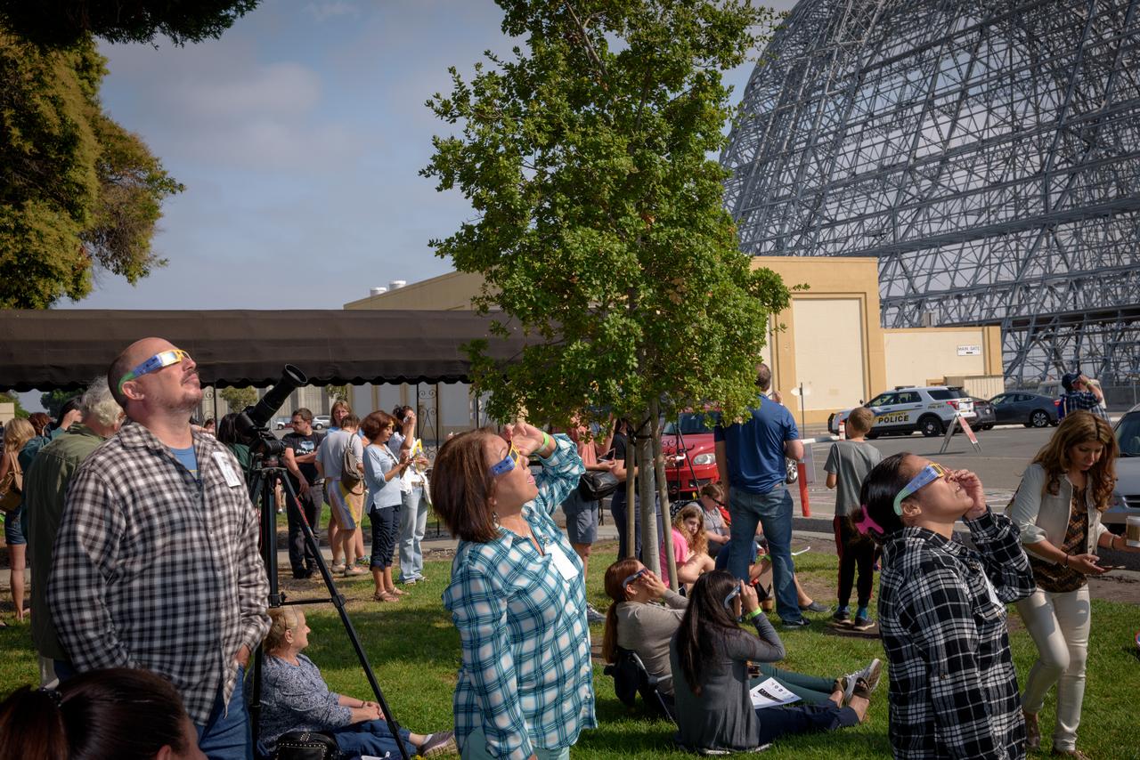 Left to Right: Raymond Tolman, Jeanie McKee and Dorothy Gasper-AIU watching the Moon's transit across the sun in front of Building 3 at NASA Ames during the 2017 Solar Eclipse.
