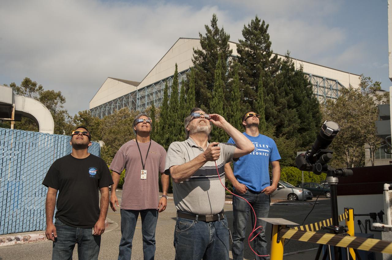 Taking a break from their duties at the Ames Vertical Gun Range to look up at the eclipse over Ames Research Center in Mountain View are from left to right are Alfredo "Freddie" Perez, Chuck Cornelison, Don Bowling, Adam Parish