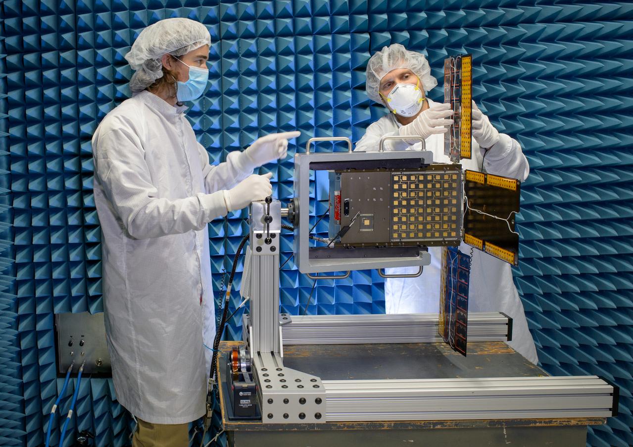Austin Bowie, left, and Jesse Fusco fold the BioSentinel flight unit solar array in the Engineering Evaluation Laboratory, or EEL, Radio Frequency test facility, N244, after completion of an electromagnetic compatibility test procedure.