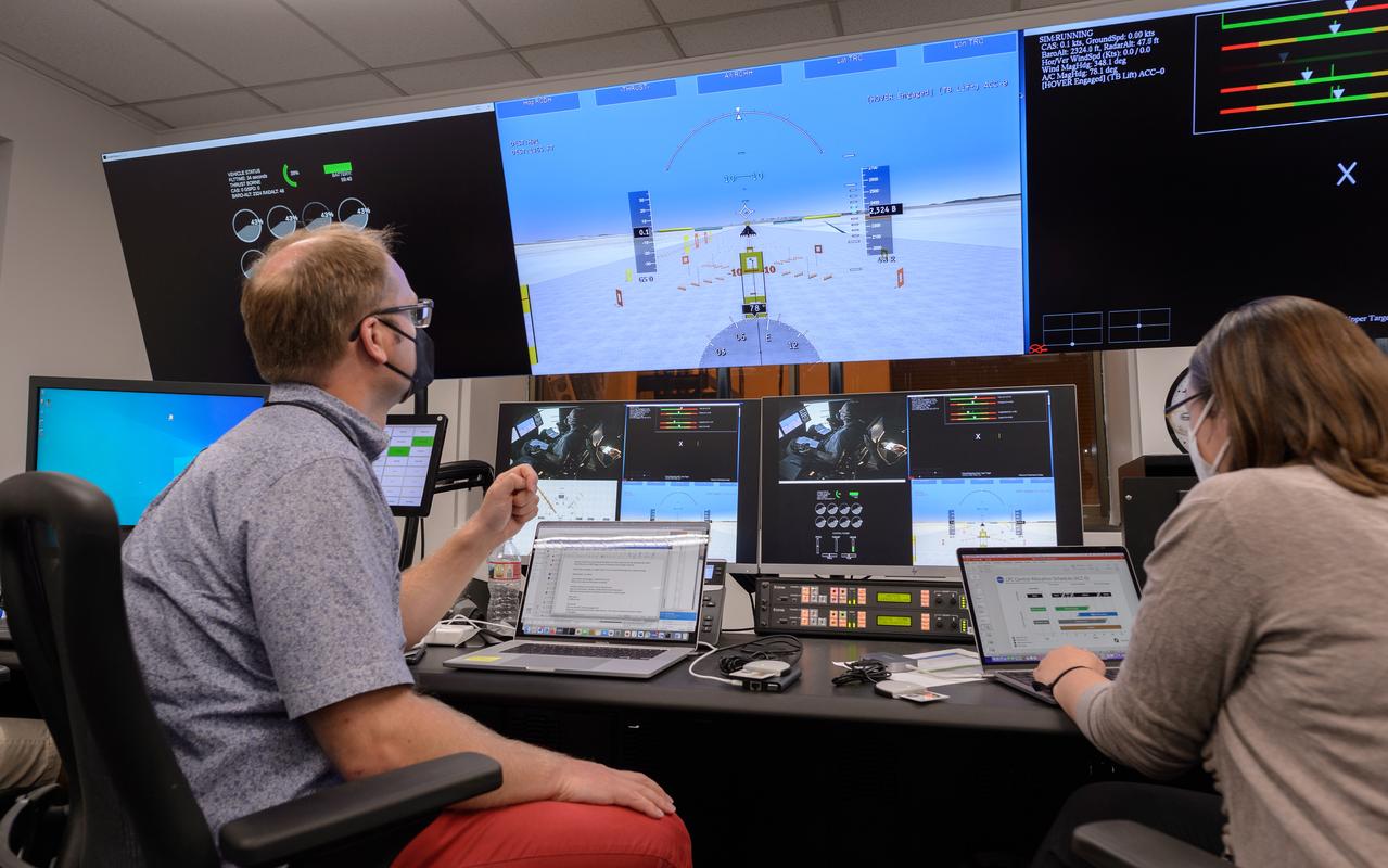 AFCM subproject simulation FAA-2 flight test team members Thomas Lombaerts, left, and Kimberlee Shish, right, in the VMS control room, N243, during a simulation.