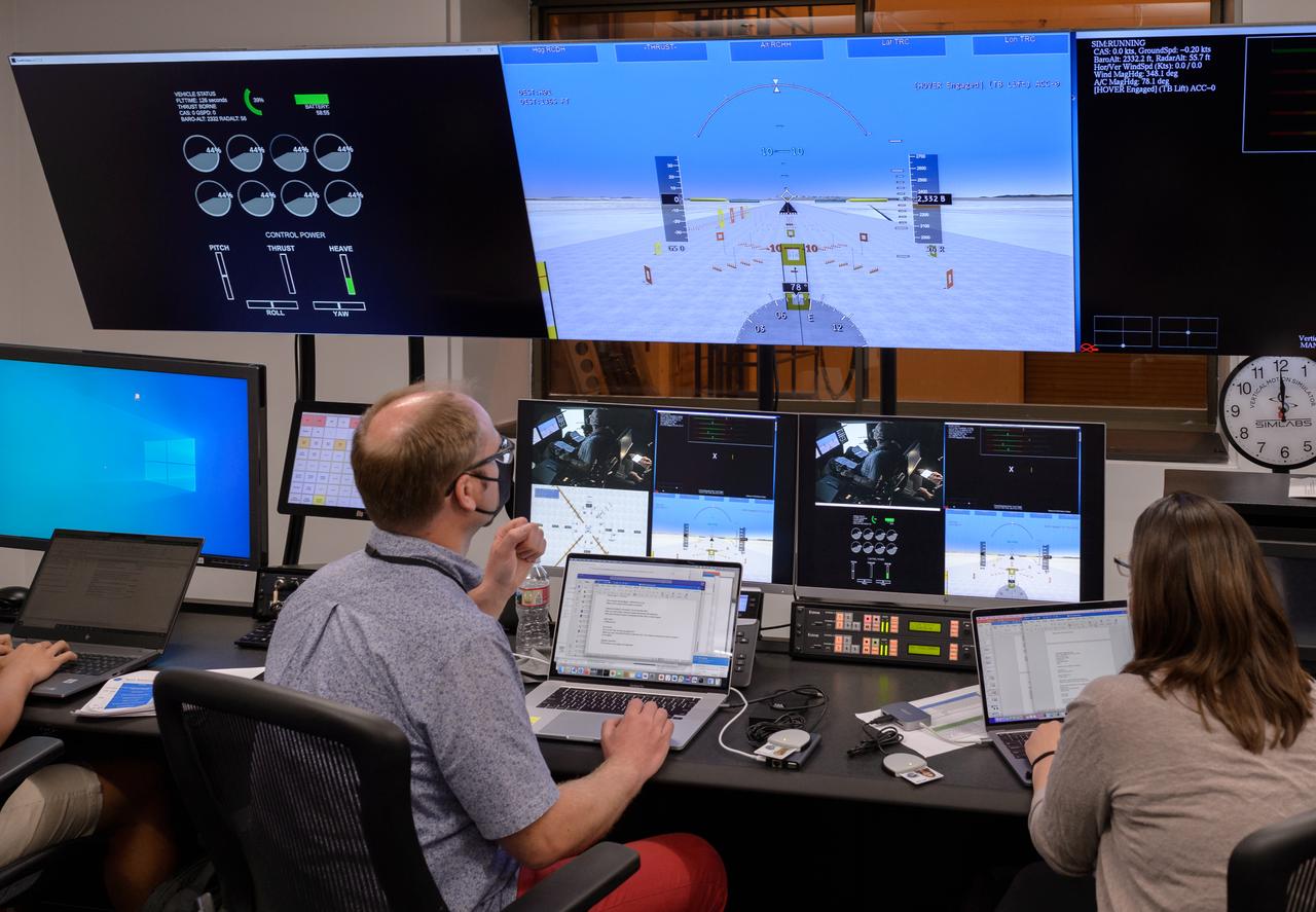 AFCM subproject simulation FAA-2 flight test team members Thomas Lombaerts, left, and Kimberlee Shish, right, in the VMS control room, N243, during a simulation.