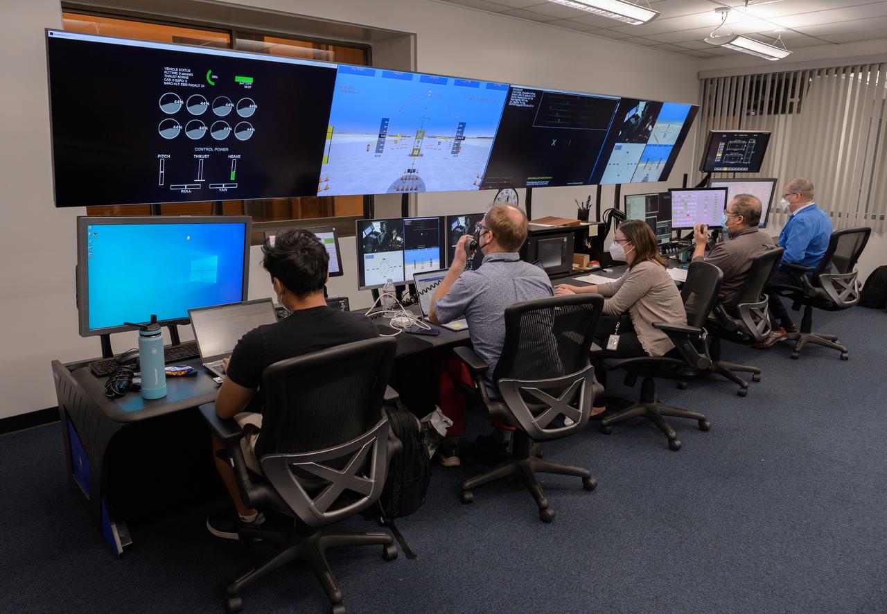 AFCM subproject simulation FAA-2 flight test team members Allen Ruan, left, Thomas Lombaerts, Kimberlee Shish, Edgar Torres, and Stephen Norris, right, in the VMS control room, N243 during a simulation.