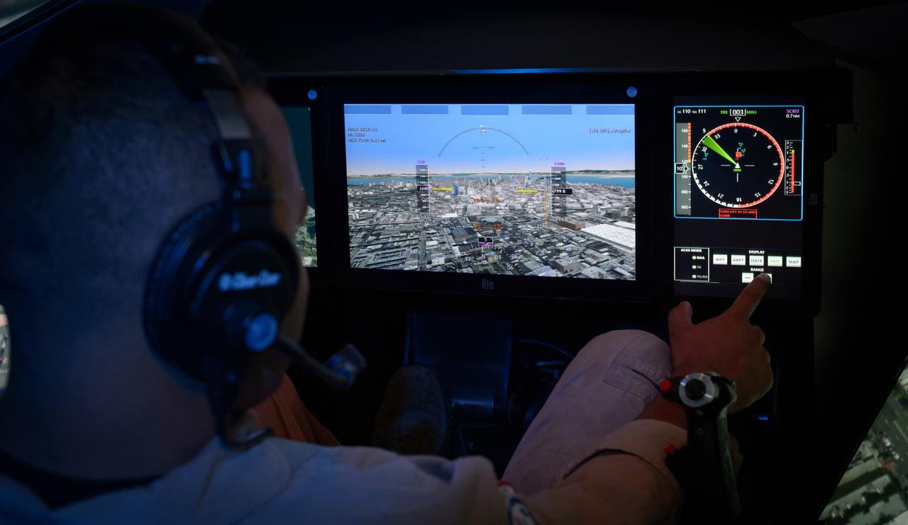 Pilot David Zahn fine-tunes the traffic display screen of the ownship aircraft in the VMS’s R-Cab during the AVA-1h simulation in the VMS, N243.