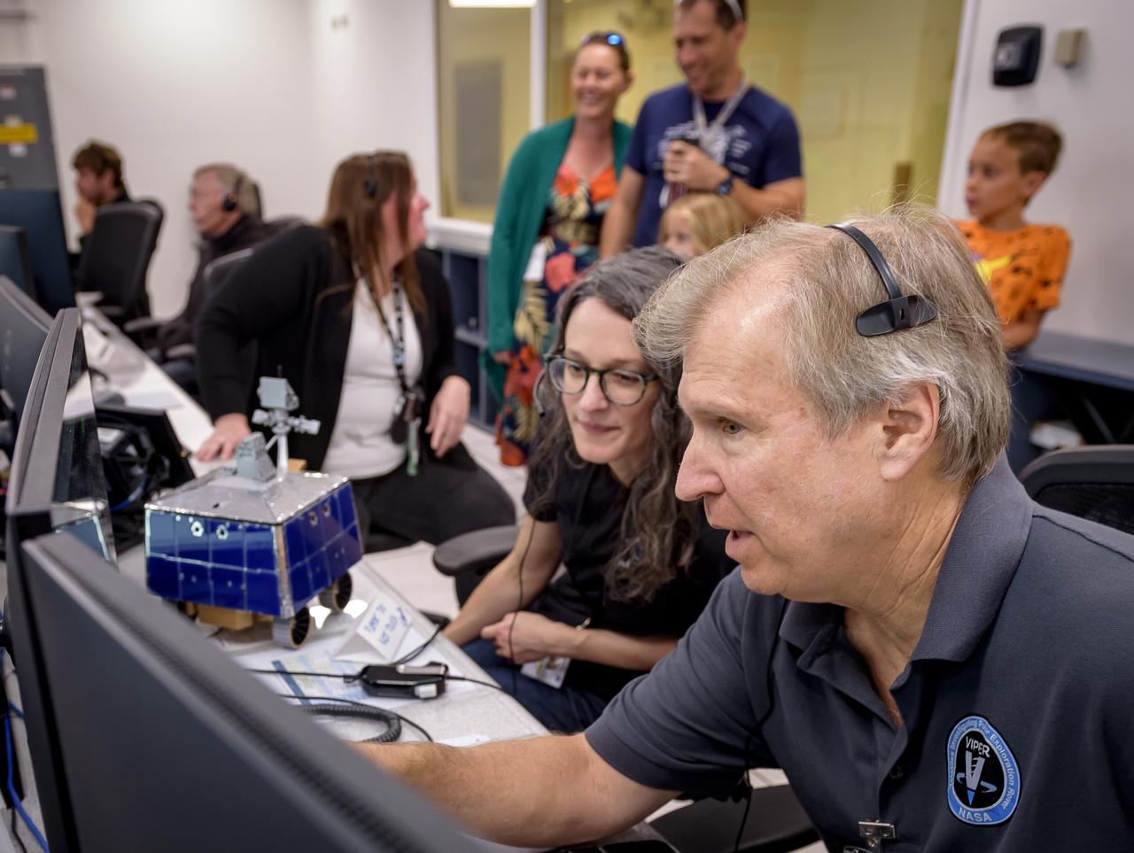 Right to left: Jay Trimble, Rachel Hoover, and Kelsey Herrmann in the Multi-Mission Operations Center (MMOC), N240, during Volatiles Investigating Polar Exploration Rover (VIPER) for VIPER Family Day.
