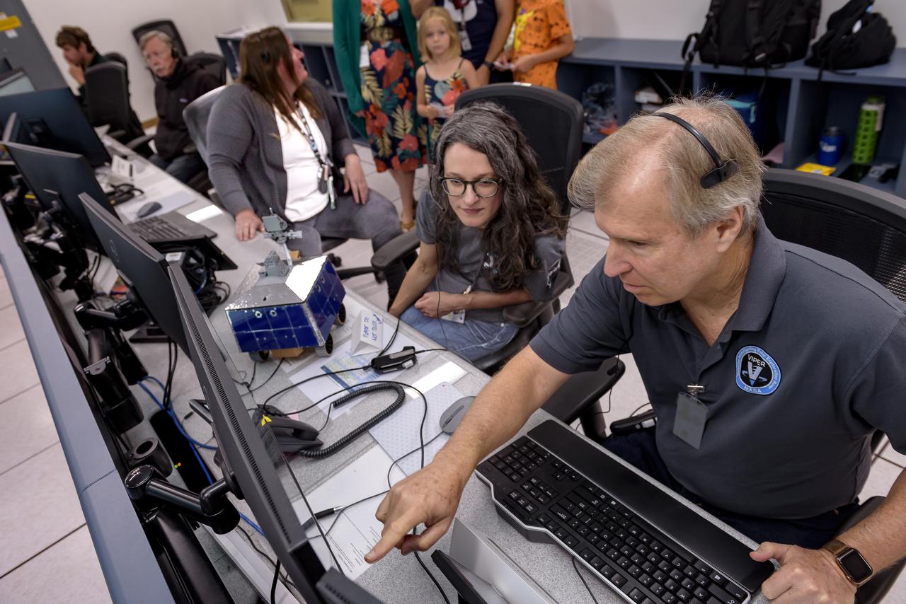 Right to left: Jay Trimble, Rachel Hoover, and Kelsey Herrmann in the Multi-Mission Operations Center (MMOC), N240, during Volatiles Investigating Polar Exploration Rover (VIPER) for VIPER Family Day.