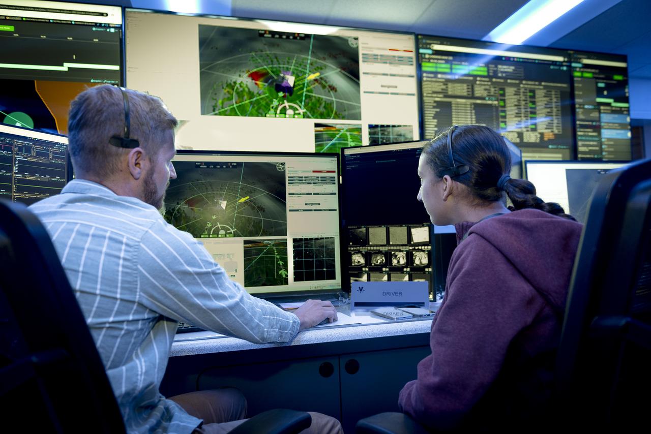 Arno Rogg explains the Volatiles Investigating Polar Exploration Rover (VIPER) mission to visitors in the Multi-Mission Operations Center (MMOC), N240, during VIPER Family Day.
