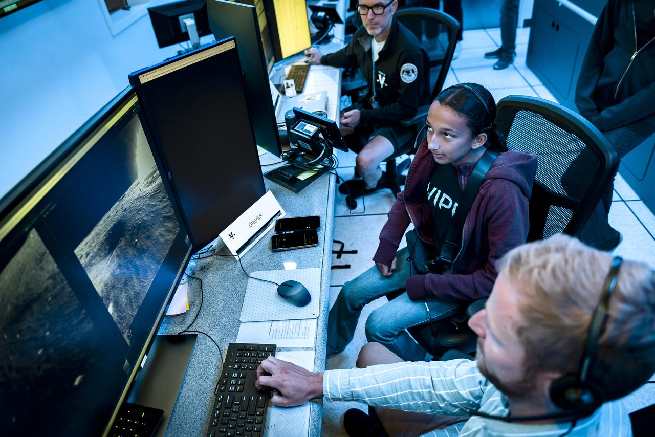 Arno Rogg explains the Volatiles Investigating Polar Exploration Rover (VIPER) mission to visitors in the Multi-Mission Operations Center (MMOC), N240, during VIPER Family Day.