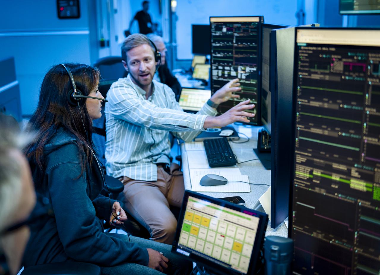Arno Rogg explains the Volatiles Investigating Polar Exploration Rover (VIPER) mission to visitors in the Multi-Mission Operations Center (MMOC), N240, during VIPER Family Day.