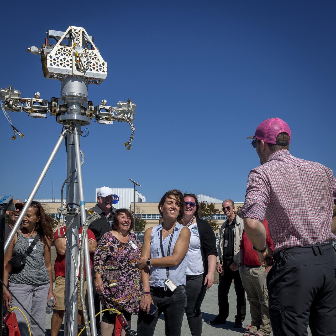 Antoine Tardy explains the operation of the Moon Gravity Representative Unit (MGRU3) at the Roverscape during Family Day for team members of the Volatiles Investigating Polar Exploration Rover (VIPER).  MGRU3 is a weight equivalent mobility and navigation test platform for VIPER. It is used to test, develop and validate the different mobility and navigation techniques and capabilities of the VIPER rover, to safely and efficiently map water at the Moon’s South Pole.