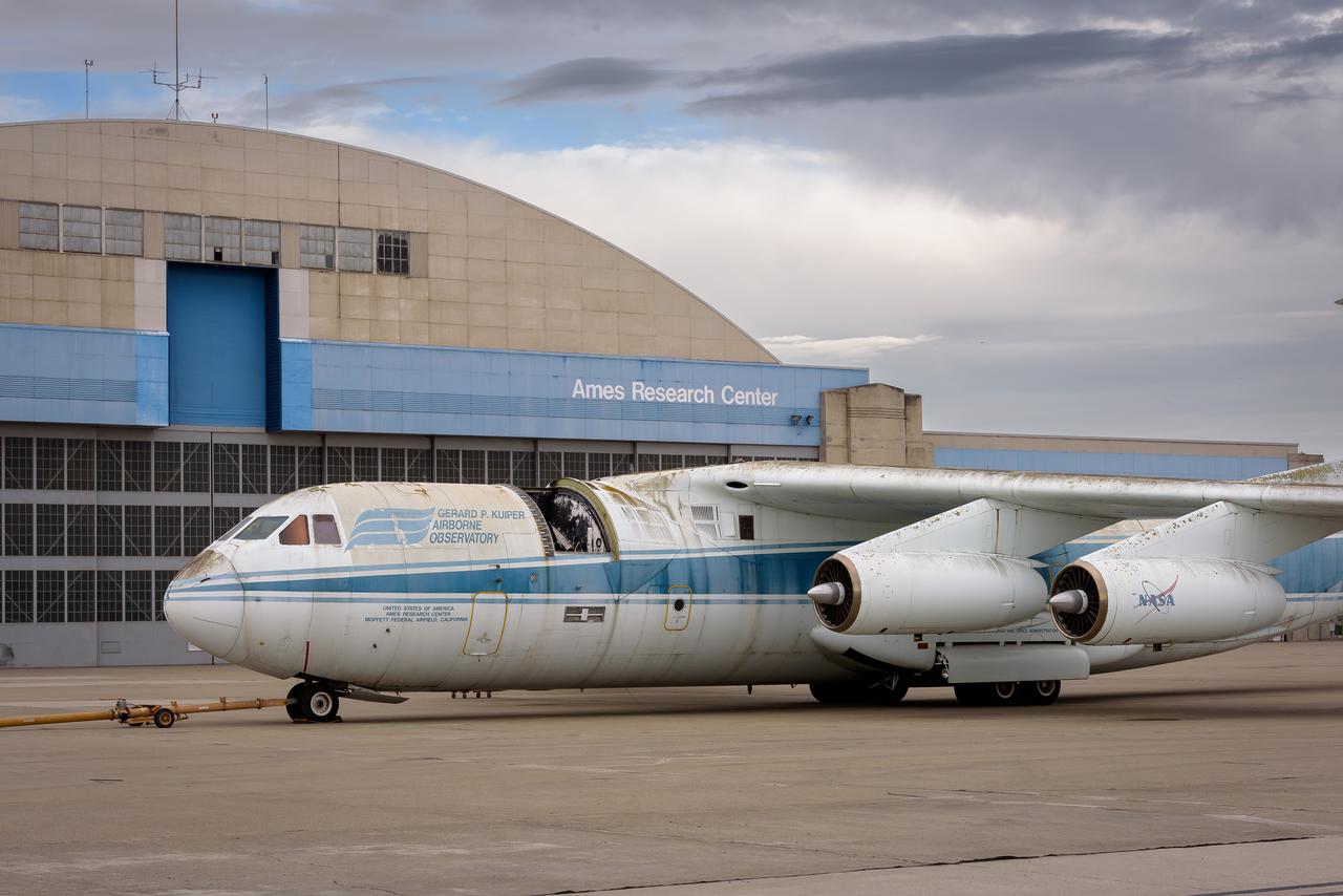 Three-quarter front view of the modified C-141 Kuiper Airborne Observatory, (KAO) (NASA-714), with the telescope aperture open on the N211 apron at Moffett Field, California.