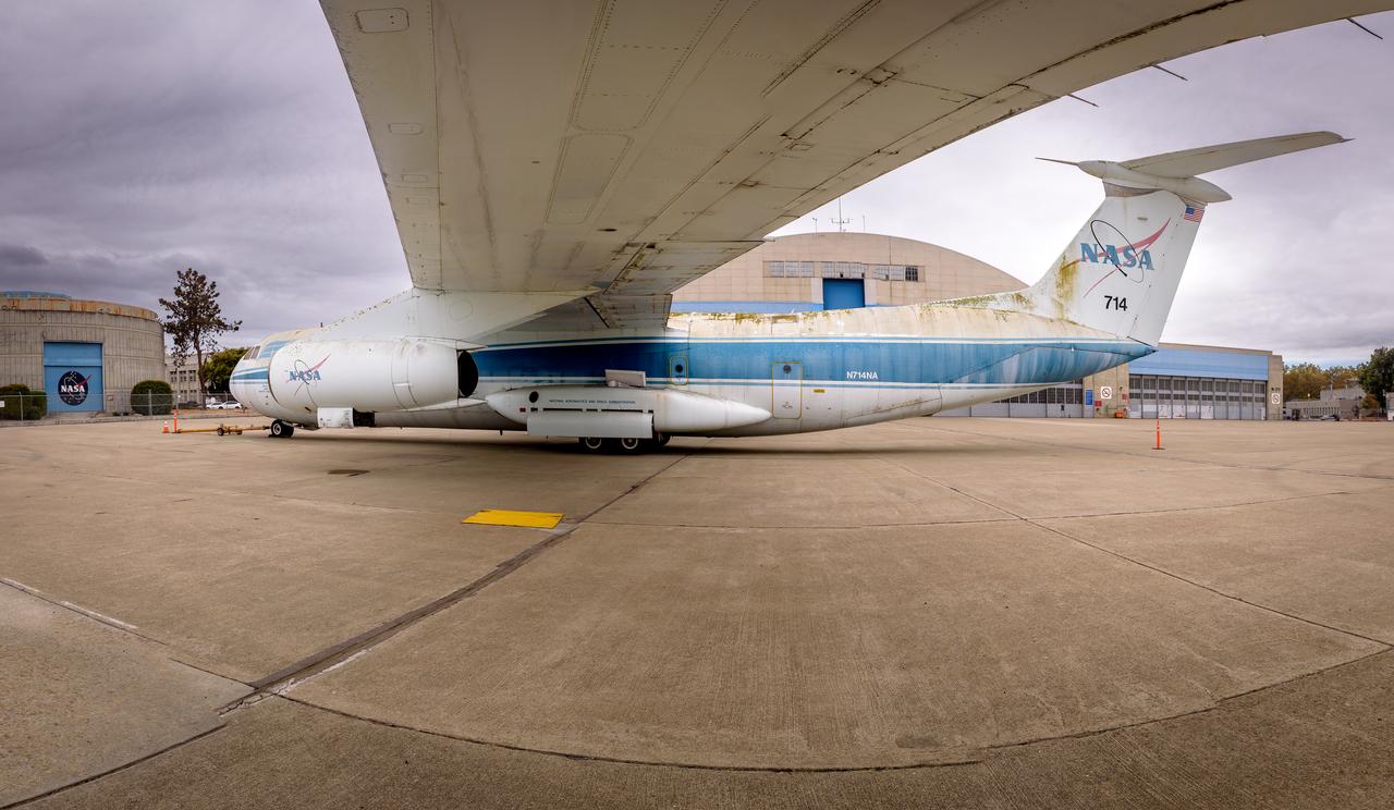 Photo composite (11 frames) of the modified C-141 Kuiper Airborne Observatory, (KAO) (NASA-714), beneath the wing on the N211 apron at Moffett Field, California.