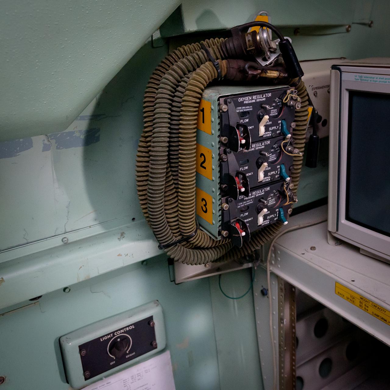 Oxygen regulator pressure demand.  Aft of the port side work area.  Everyone flying on the Kuiper Airborne Observatory, (KAO) (NASA-714), needed to have their own oxygen mask and operate their regulator.