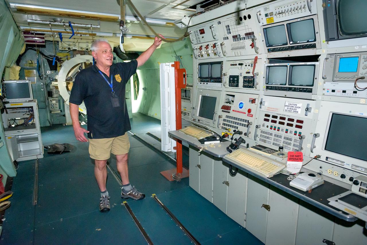 Mission Director Stephen Patterson at his workstation at the console of the modified C-141 Kuiper Airborne Observatory, (KAO) (NASA-714).