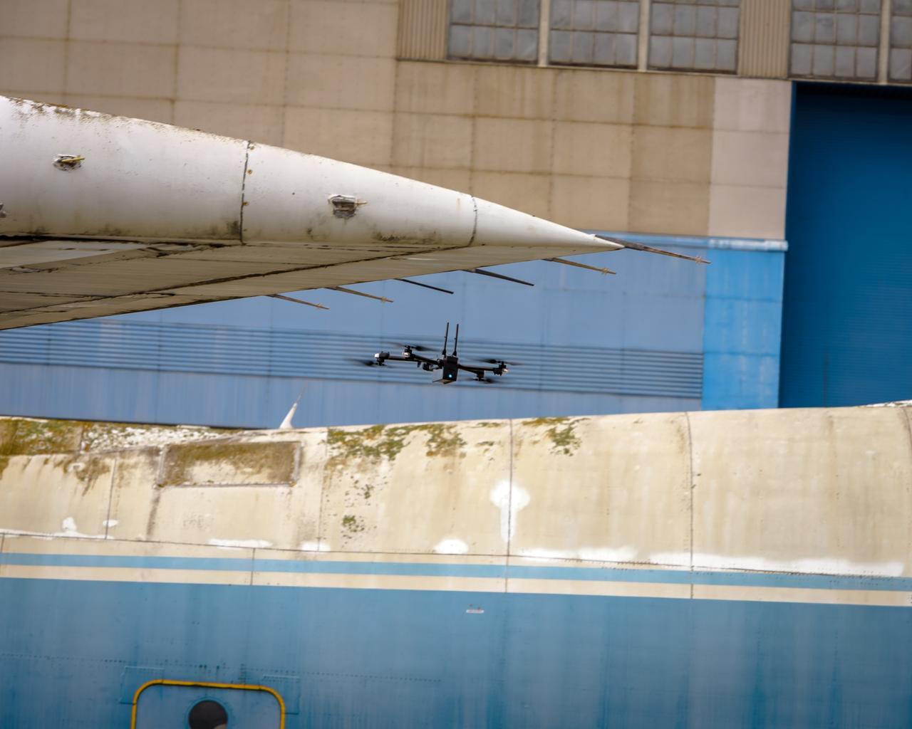 The drone follows an autonomously defined path around the modified C-141 Kuiper Airborne Observatory, (KAO) (NASA-714), on the N211 apron.  The drone photographs the aircraft with a visible and infrared camera which are processed using a photogrammetry software package called Pix4D that converts them into a 3D model.  Scanning the aircraft is the first phase of documenting the aircraft demolition as well as an opportunity to train pilots to operate the Pix4D software.