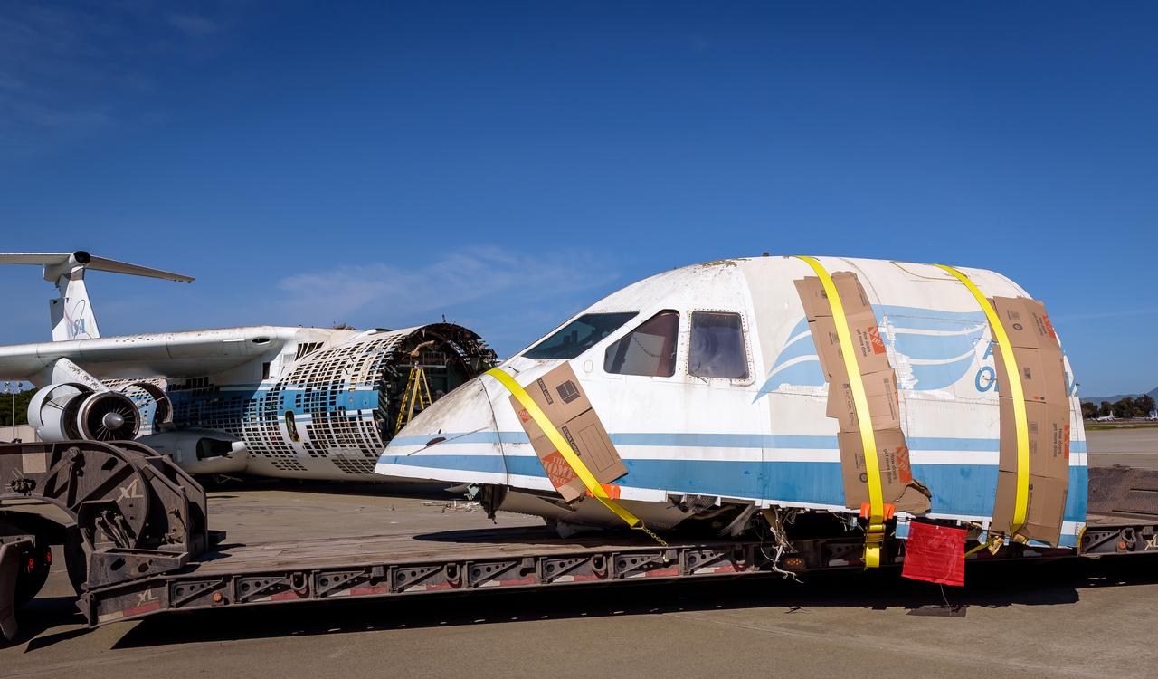 Yellow straps fasten the cockpit of the modified C-141 Kuiper Airborne Observatory, (KAO) (NASA-714), to the trailer that carries it off the N211 apron at Moffett Field, California.