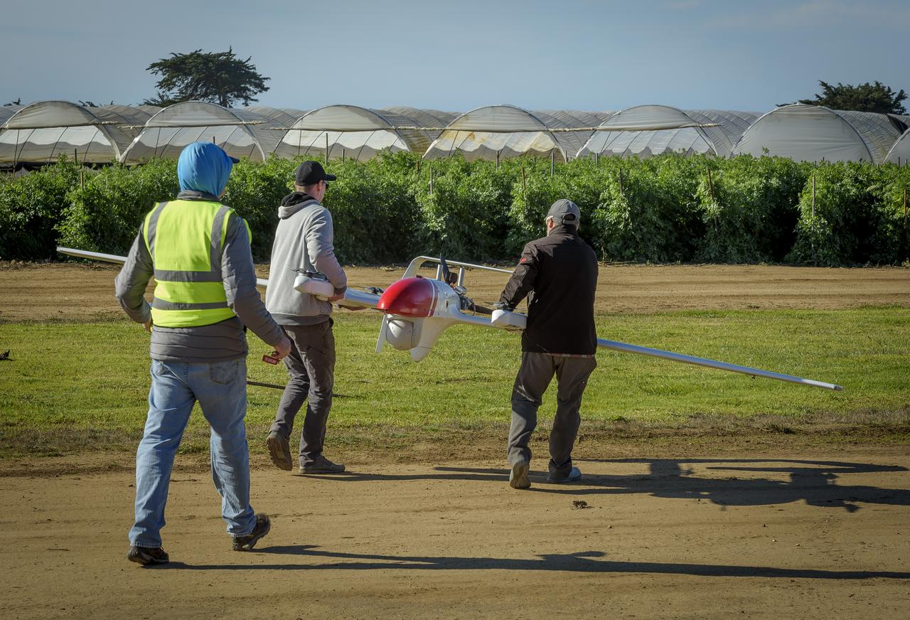 Jody Miller, left, Alex Godwin, and Jeff Strebler, right, prepares the L3Harris FVR90 Unmanned Aerial Vehicle (UAV) at the Monterey Bay Academy Airport near Watsonville, California.