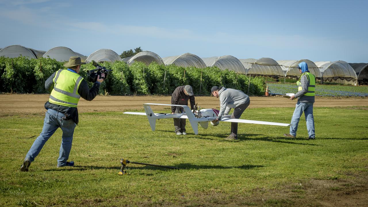 Ames video photographer Jesse Carpenter, left, films Jeff Strebler, Alex Godwin, and Jody Miller, right, as they prepare the L3Harris FVR90 Unmanned Aerial Vehicle (UAV) at the NASA/Overwatch Aero station at the Monterey Bay Academy Airport near Watsonville, California.