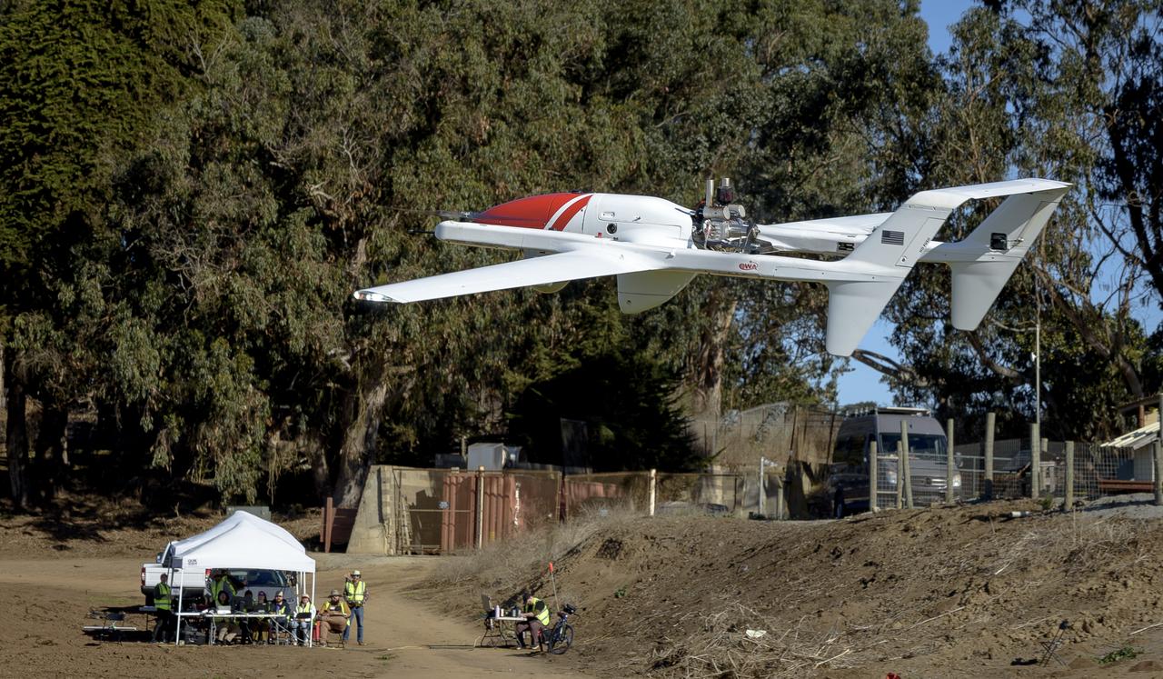 L3Harris FVR90 Unmanned Aerial Vehicle (UAV) lifts off from the Monterey Bay Academy Airport near Watsonville, California, during the Advanced Capabilities for Emergency Response Operations (ACERO) Shakedown Test as NASA researchers observe in the background.