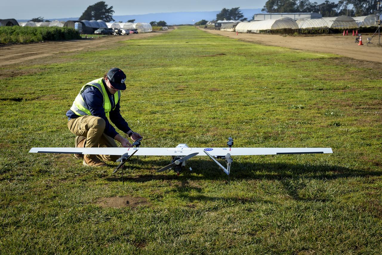 Brayden Chamberlain, preps the SuperVolo XL Unmanned Aerial Vehicle (UAV) for flight at the Monterey Bay Academy Airport near Watsonville, California.