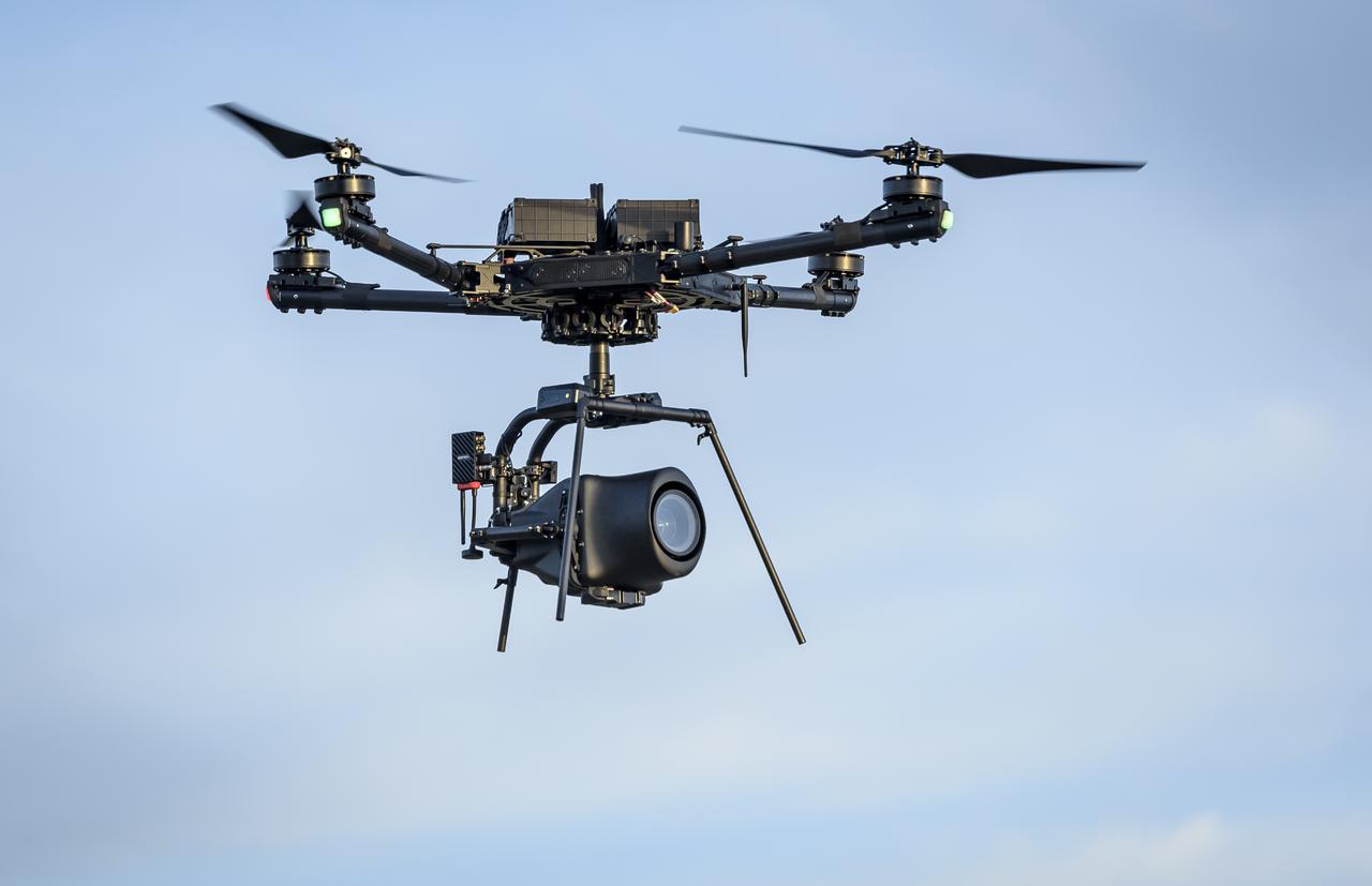 The Alta-X Unmanned Aerial Vehicle (UAV) with camera payload in flight at the Monterey Bay Academy Airport near Watsonville, California.