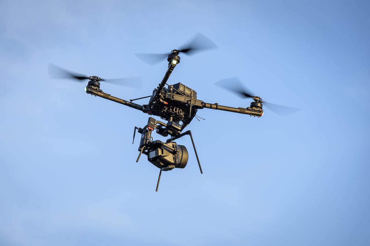 The Alta-X Unmanned Aerial Vehicle (UAV) with camera payload in flight at the Monterey Bay Academy Airport near Watsonville, California.