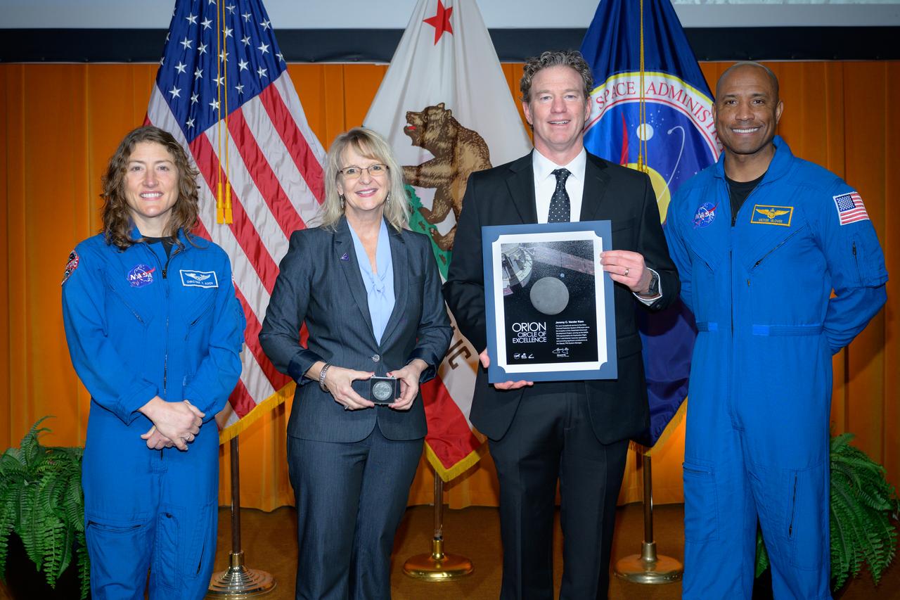 Artemis Orion Circle of Excellence Award presented to Jeremy Vander Kam, center, by Orion Deputy Program Manager Debbie Korth, left, NASA astronauts Victor J. Glover, right, and Christina Koch, left, in the N201 auditorium.